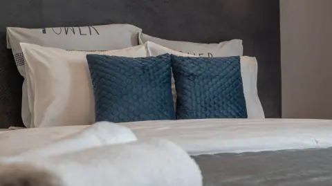 Blue cushions and bed linen in the guesthouse room