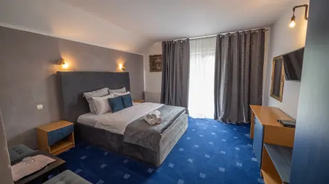 Double bed and balcony window in the blue room