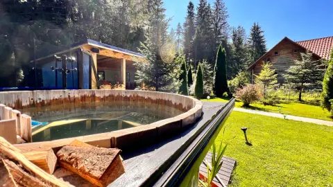 Wooden hot tub in the guesthouse garden beside the forest