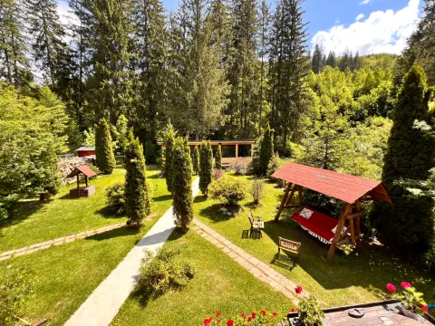 Elevated garden view with lawn, paths and swings