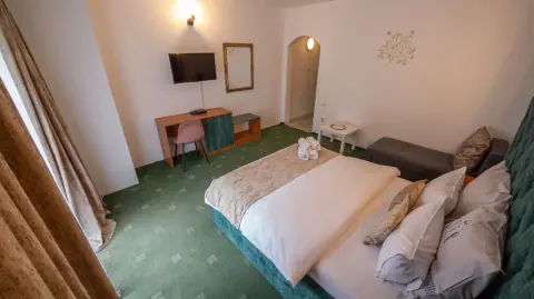 Double bedroom with a sofa and television