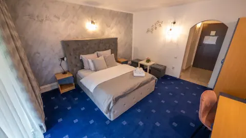 Double bed, armchair and wardrobe in the blue room