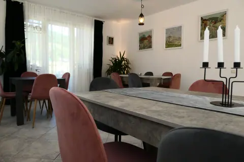 Dining room with chairs and windows towards the garden