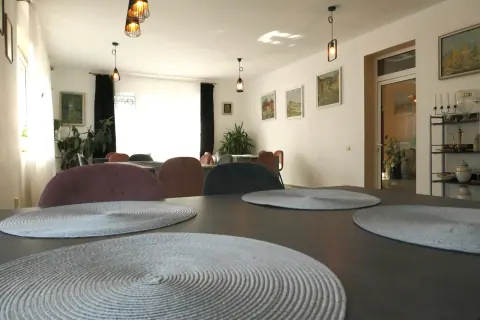 Tables and chairs in the bright guesthouse dining room