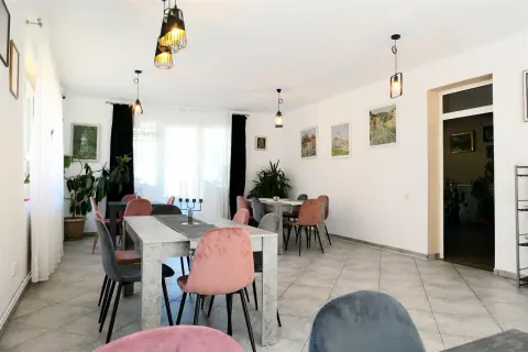 View towards the dining room tables and windows